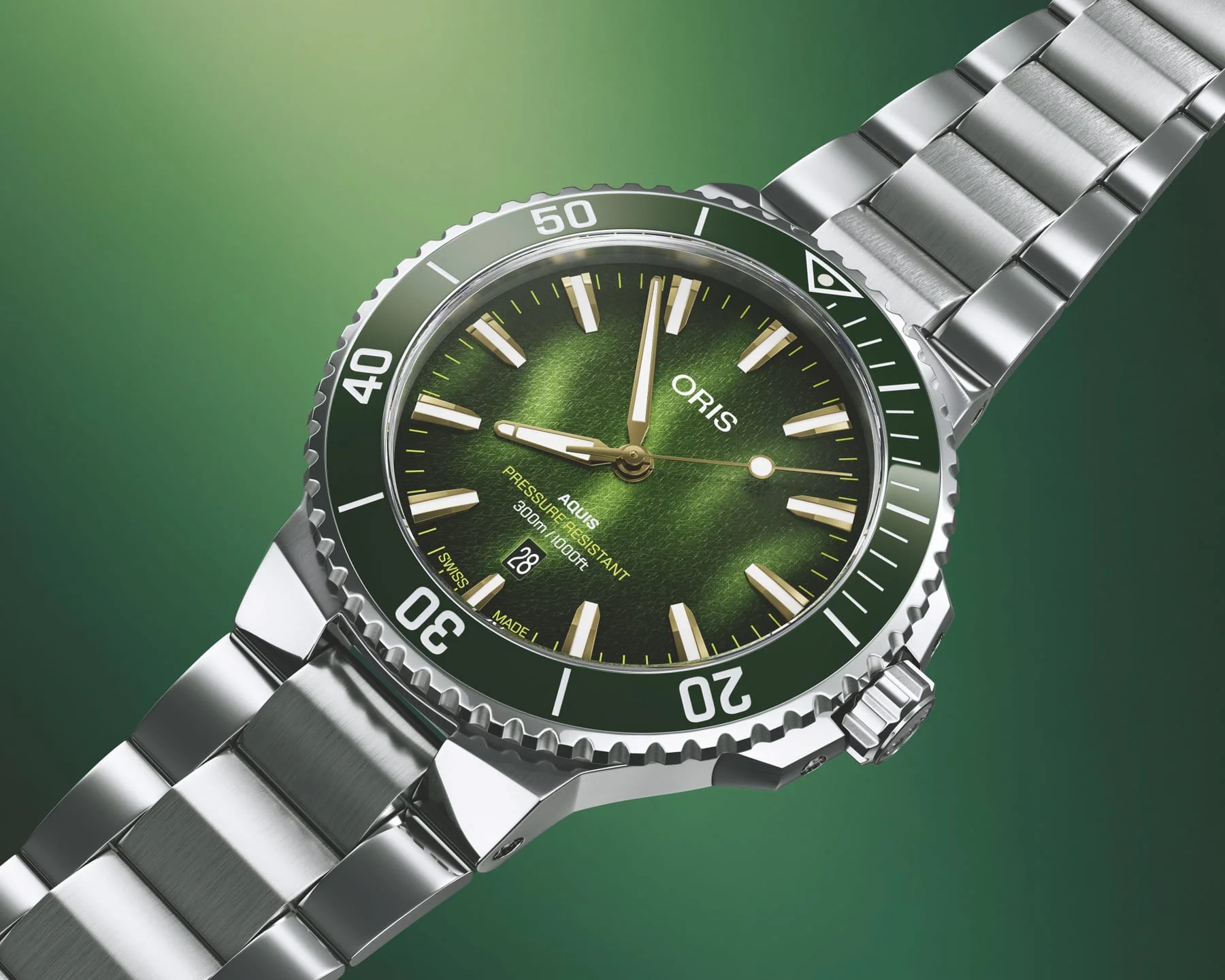 Oris Aquis Date Kelp Forest Limited Edition 01 733 7787 4187-Set mit grünem Zifferblatt, grüner Keramiklünette und Edelstahlband vor grünem Hintergrund